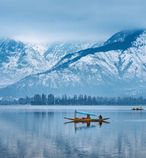 A view of Dal Lake in winter, and the beautiful mountain range in the background in the city of Srinagar, Kashmir, India.