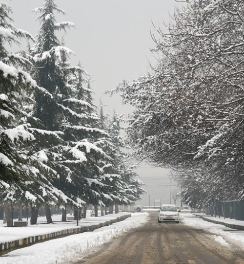 Srinagar: A vehicle moves slowly on a snow-covered road after a fresh snowfall, in Srinagar, Sunday, Jan. 3, 2021. (PTI Photo/S Irfan)(PTI01_03_2021_000075A)